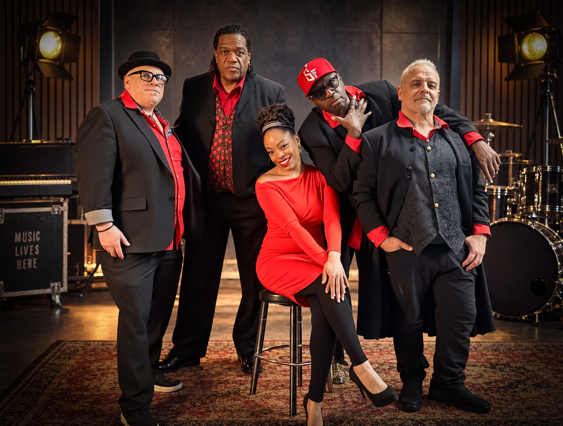 Slick Fantaztic band in red and black outfits with Michelle Hill in a red dress